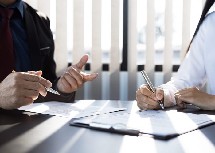 the home insurance salesman and the customer are signing an insu